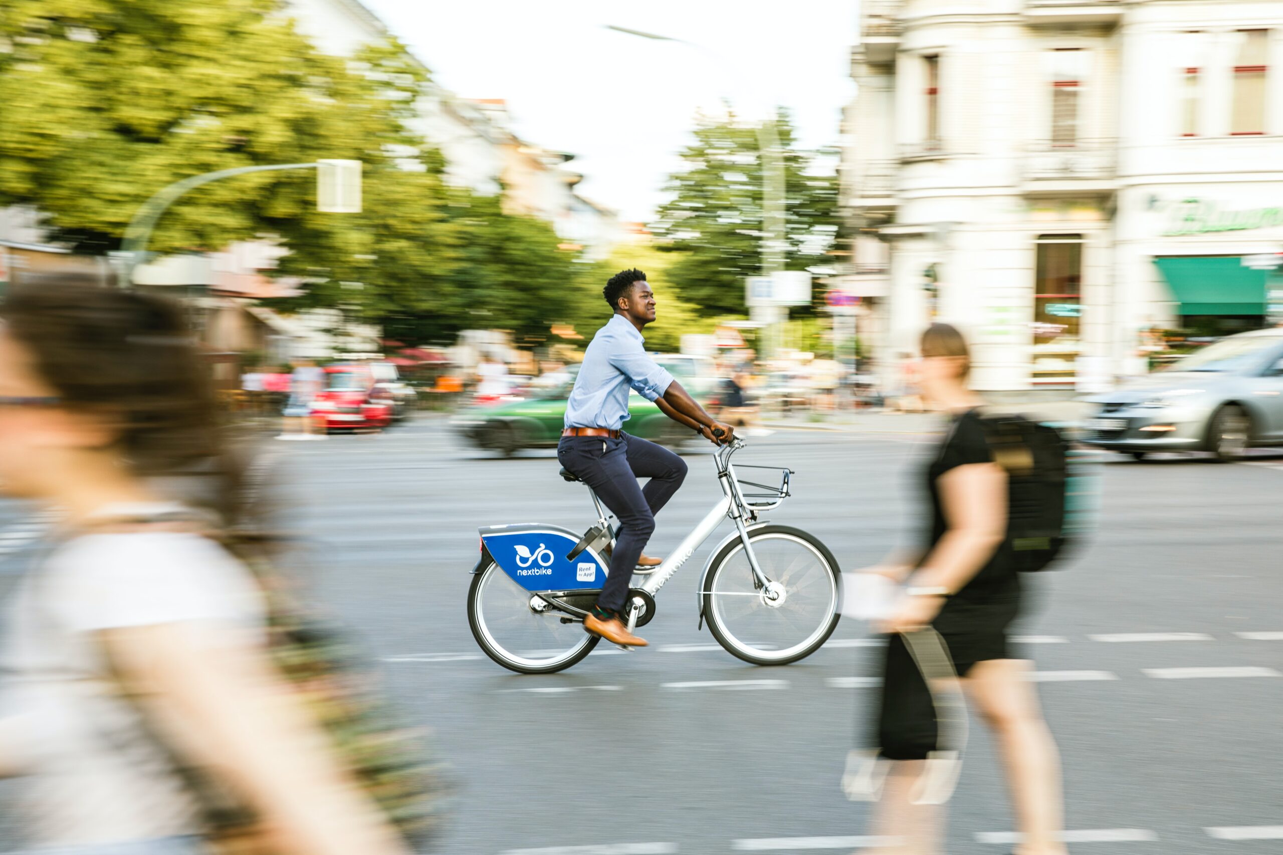 Man cycling down a sunny street