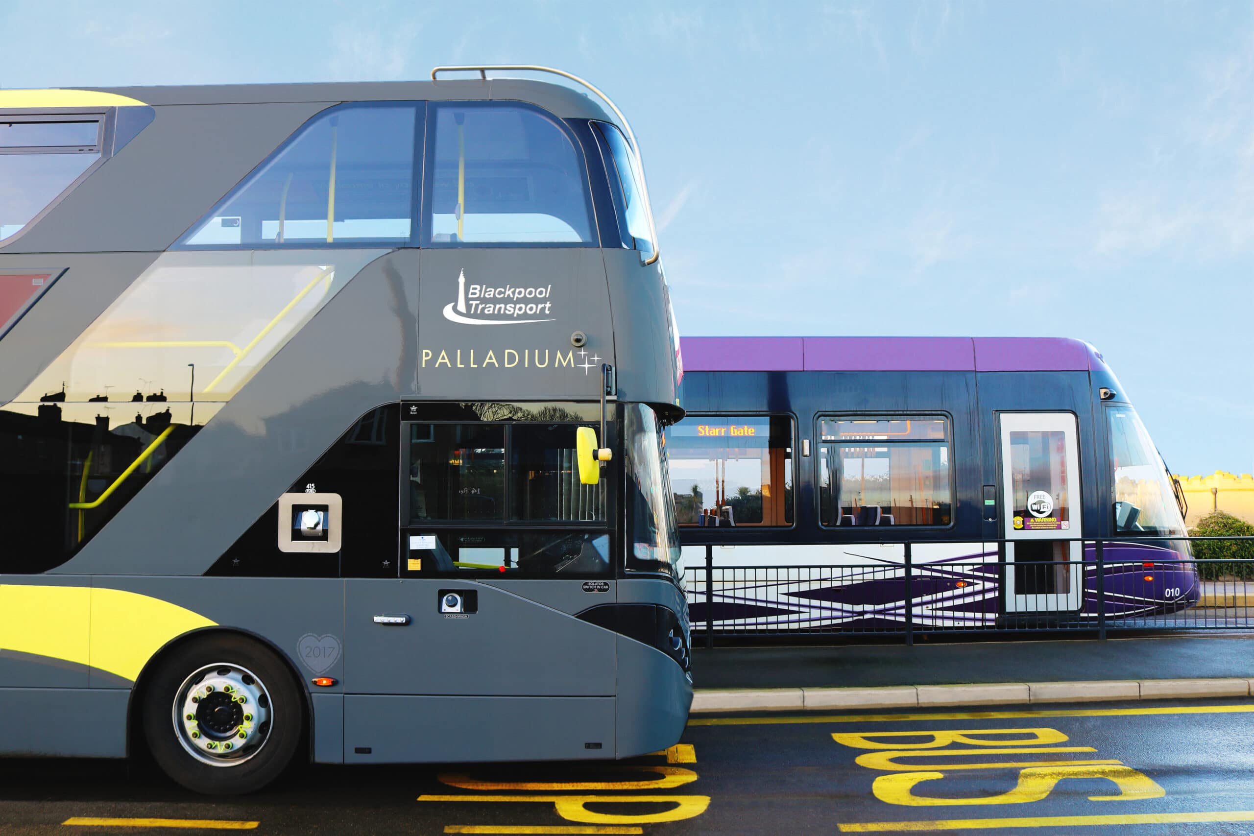 Blackpool Transport Bus & Tram driving along a road.