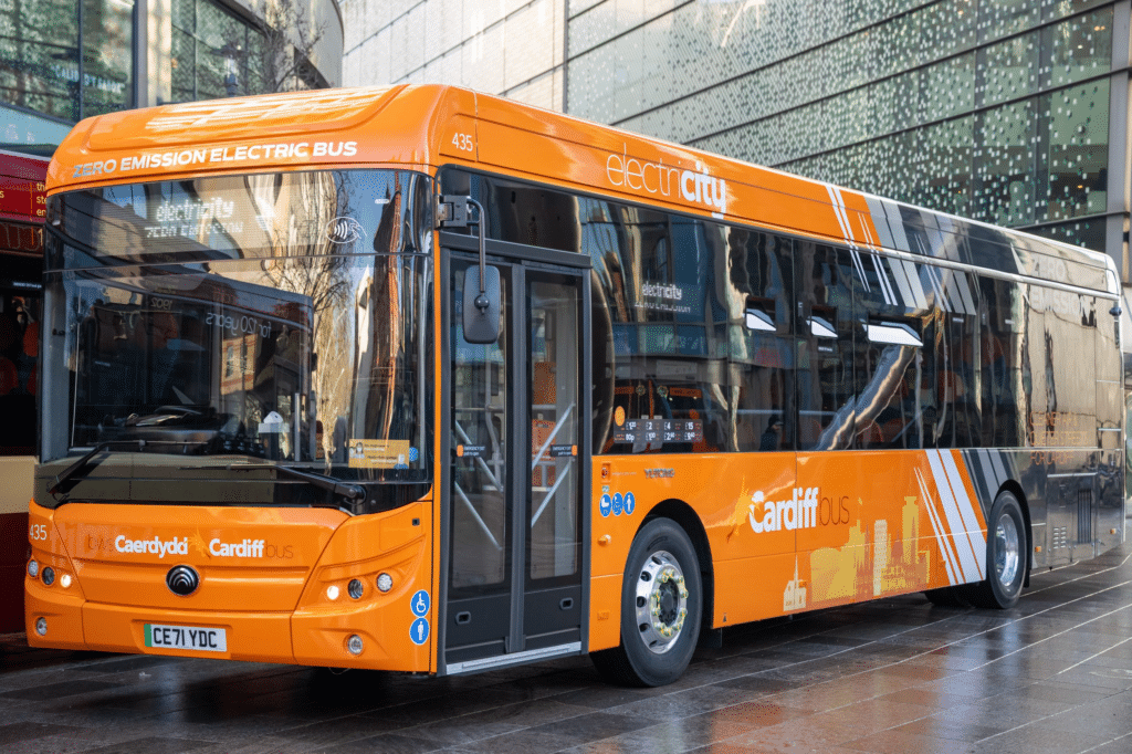 An electric Yutong E12 bus wearing Cardiff Bus' new orange and dark grey livery
