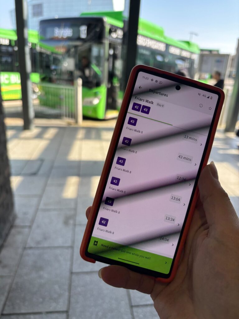 A mobile phone displaying a real time departure board in the Newport Bus app