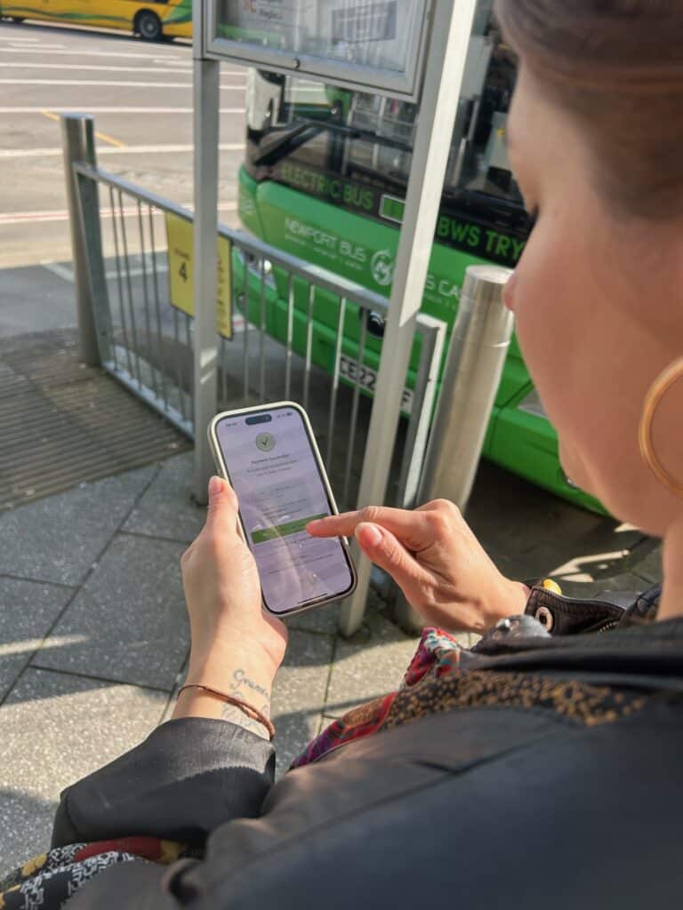 Gemma purchasing a ticket in the Newport Bus app at Newport Bus Station